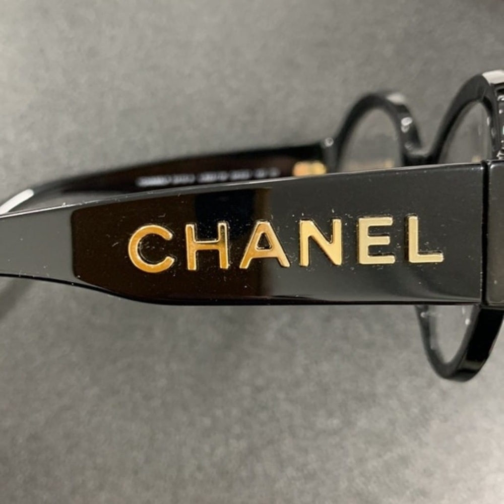 CHANEL Black Glasses with Gold Detailing.             54 21 140